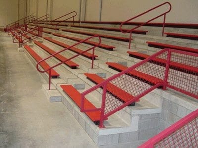 red bleachers on concrete foundation