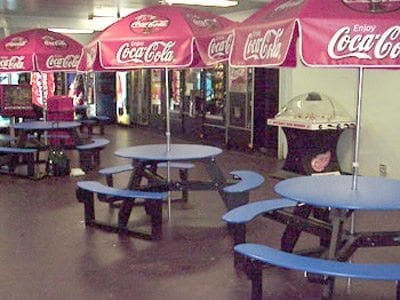 round picnic tables in lobby area of ice arena