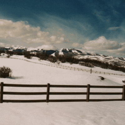 3-rail redwood fence line in winter