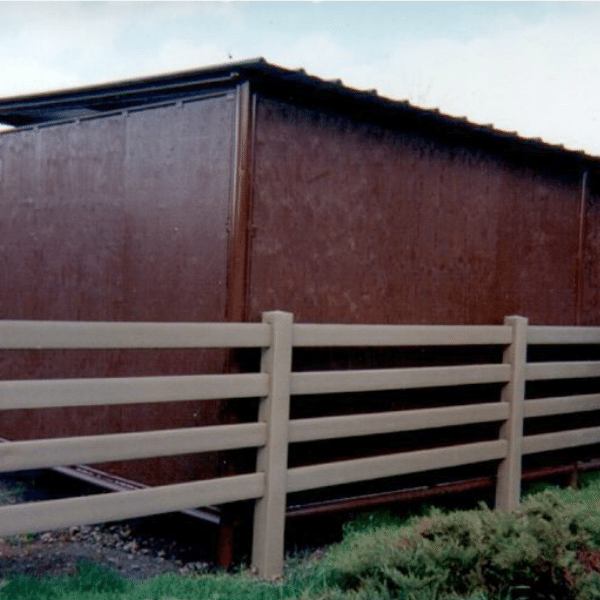 four rail fence behind shed around paddock